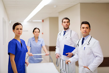 Image showing group of doctors with gurney at hospital