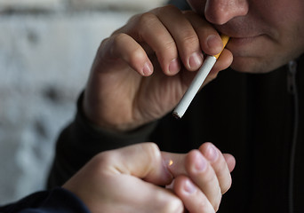 Image showing close up of young people smoking cigarette