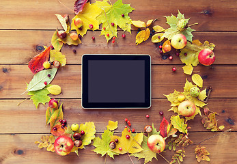 Image showing tablet pc with autumn leaves, fruits and berries