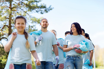 Image showing group of volunteers with garbage bags in park