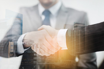 Image showing two businessmen shaking hands in office