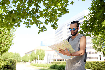 Image showing man traveling with backpack and map in city