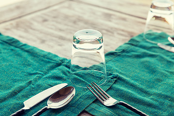 Image showing close up of cutlery with glass and napkin on table