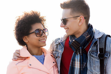 Image showing happy teenage friends in shades talking outdoors