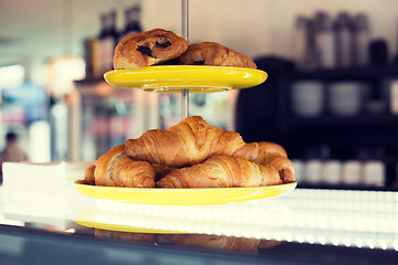 Image showing close up of croissants and buns on cake stand