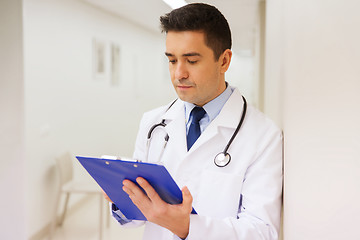 Image showing doctor writing to clipboard at hospital
