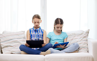 Image showing girls with tablet pc sitting on sofa at home