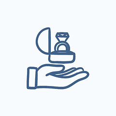 Image showing Hand holding gift box with ring sketch icon.