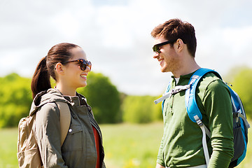 Image showing happy couple with backpacks hiking outdoors