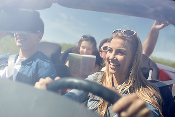 Image showing happy friends driving in cabriolet car