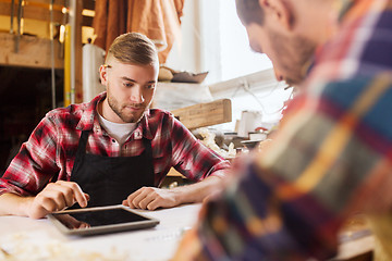 Image showing workmen with tablet pc and blueprint at workshop