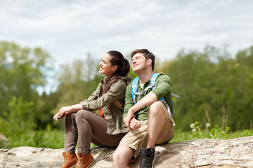 Image showing smiling couple with backpacks in nature