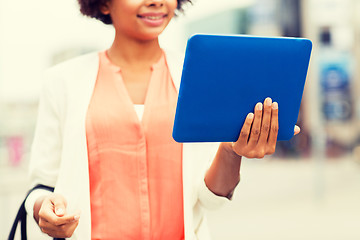 Image showing close up of african woman with tablet pc in city