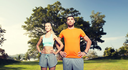 Image showing happy couple exercising over summer park
