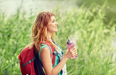 Image showing woman with backpack and bottle of water hiking