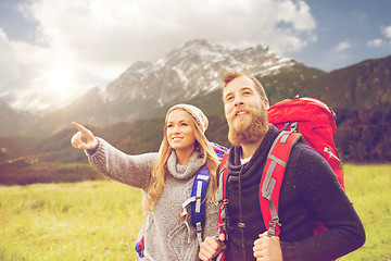 Image showing smiling couple with backpacks hiking