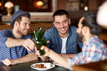 Image showing happy male friends drinking beer at bar or pub