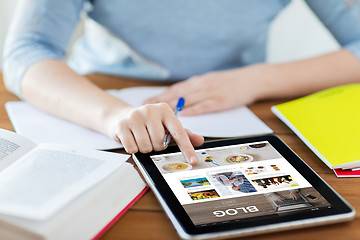 Image showing close up of student with tablet pc and notebook