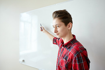 Image showing student boy showing something on blank white board