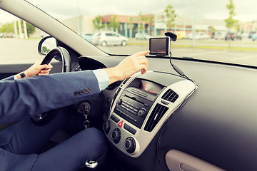 Image showing close up of man with gps navigator driving car