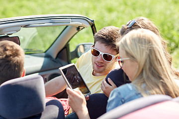 Image showing friends with tablet pc driving in cabriolet car