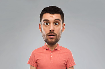 Image showing surprised man in polo t-shirt over gray background