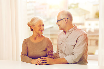 Image showing happy senior couple sitting on sofa at home