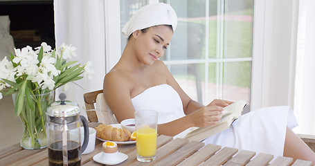 Image showing Gorgeous young woman relaxing with a book