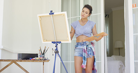 Image showing Attractive woman artist painting on her patio