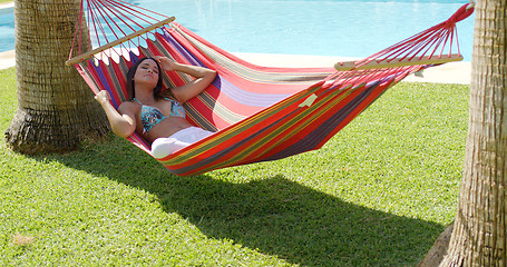 Image showing Relaxing young woman in colorful hammock