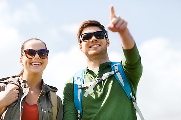 Image showing happy couple with backpacks hiking outdoors