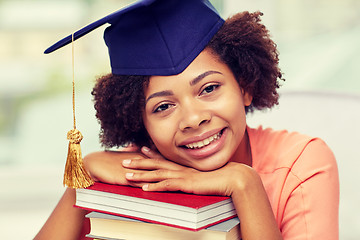 Image showing happy african bachelor girl with books at home