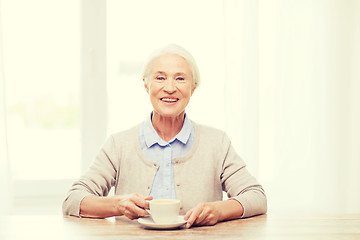 Image showing happy senior woman with cup of coffee