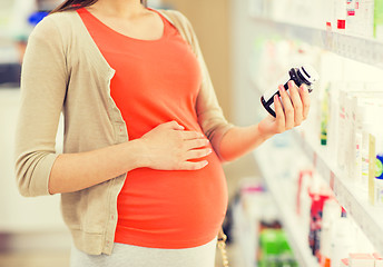 Image showing pregnant woman with medication at pharmacy