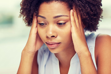 Image showing close up of african young woman touching her head