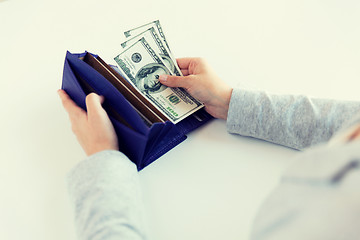 Image showing close up of woman hands with wallet and money