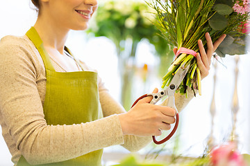 Image showing close up of woman with flowers and scissors