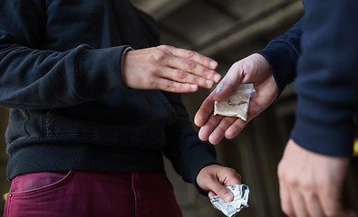 Image showing close up of addict buying dose from drug dealer