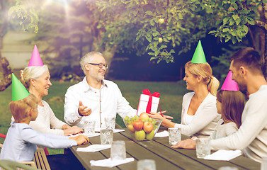 Image showing happy family having holiday dinner outdoors