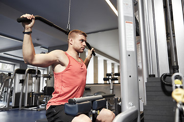 Image showing man flexing muscles on cable machine gym