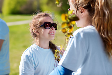 Image showing volunteers family with tree seedling in park