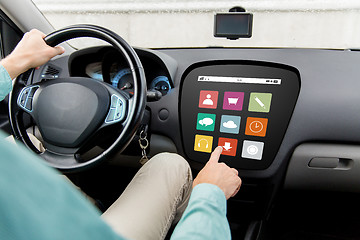 Image showing man driving car with menu icons on board computer