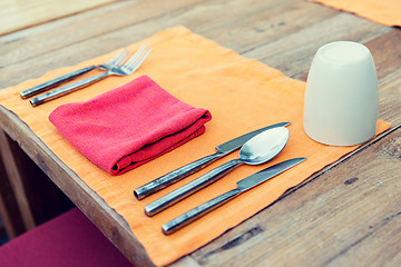 Image showing close up of cutlery with glass and napkin on table