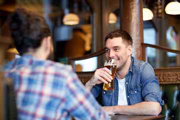 Image showing happy male friends drinking beer at bar or pub