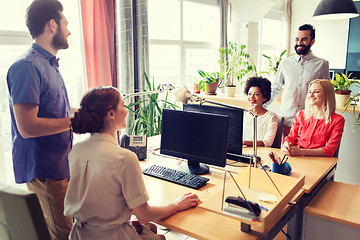 Image showing happy creative team talking in office