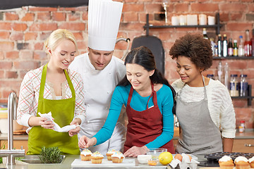 Image showing happy women and chef cook cooking in kitchen