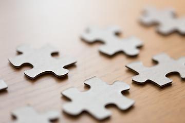 Image showing close up of puzzle pieces on wooden surface