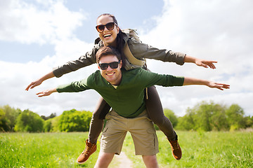 Image showing happy couple with backpacks having fun outdoors