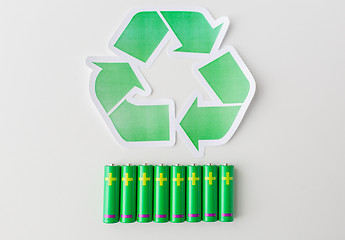 Image showing close up of batteries and green recycling symbol