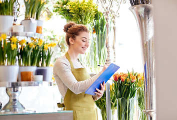 Image showing florist woman with clipboard at flower shop